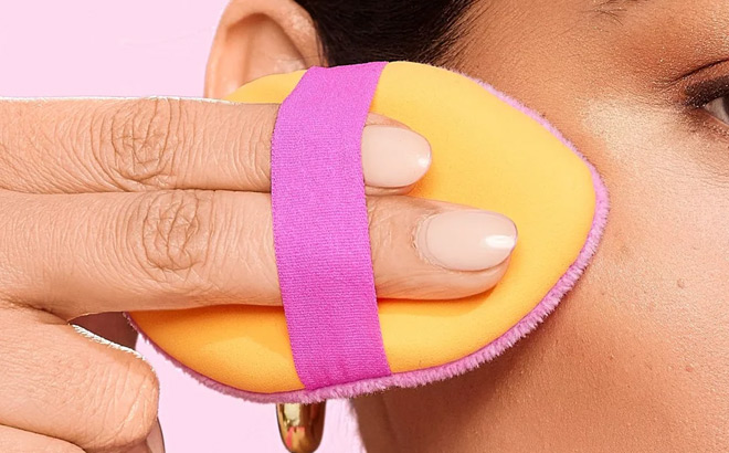 a Woman Using Real Techniques Powder Puff a Woman Using Real Techniques Powder Puff