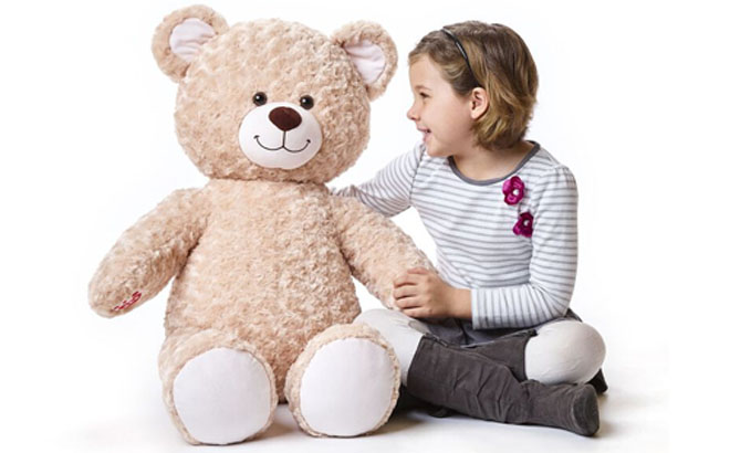 A Girl Playing with Giant Happy Hugs Teddy Bear