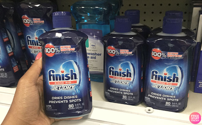 A Hand Holding Finish Jet Dry Rinse Aid