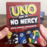 A Hand Holding UNO Show Em No Mercy Card Game