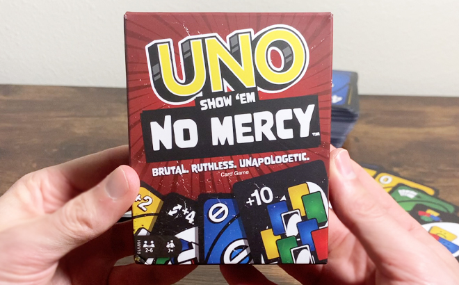 A Hand Holding UNO Show Em No Mercy Card Game