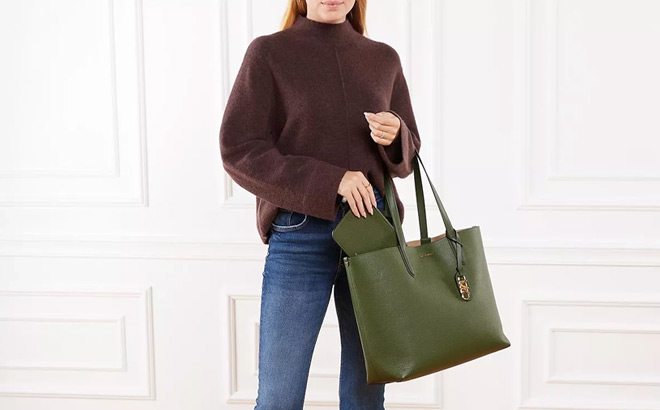 A Lady Carrying a Michael Kors Extra Large Leather Reversible Tote in Amazon Green Color