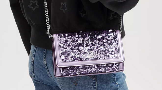 A Person Wearing Coach Glitter Flap Crossbody Bag