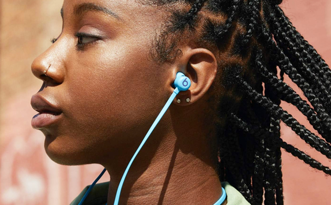 A Woman Wearing Beats Flex All Day Wireless Earphones in Blue Color