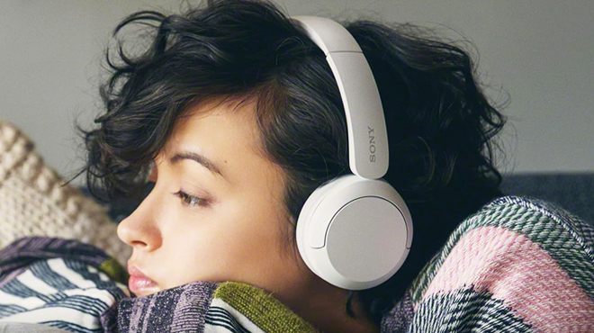 A Woman Wearing Sony Wireless Headphones Bluetooth in White Color