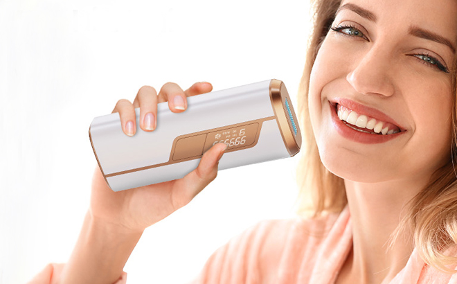 A person holding the IPL Laser Hair Removal Device near her face