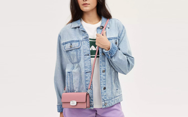 Person Wearing Coach Outlet Eliza Small Flap Crossbody Pink