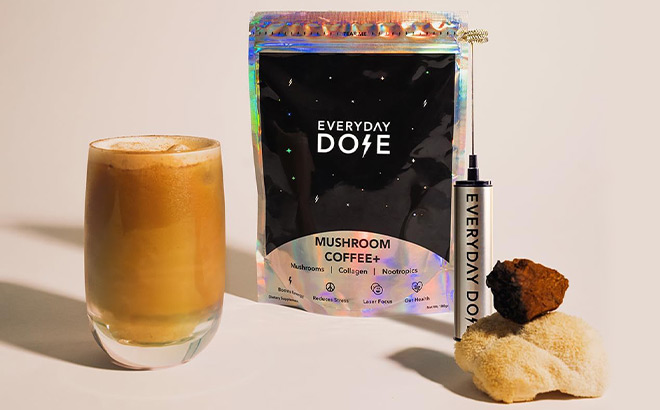 Coffee Glass next to Everyday Dose Mushroom Coffee next to a Frother