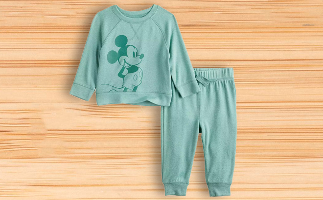 Disneys Mickey Mouse Baby Cozy Knit Graphic Sweatshirt Jogger Pants Set on a Wooden Surface