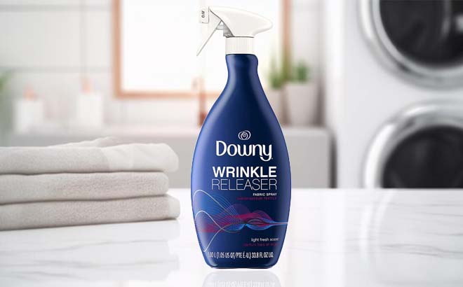 Downy Wrinkle Releaser and Refresher Fabric Spray in Light Fresh Scent on a Bathroom Counter