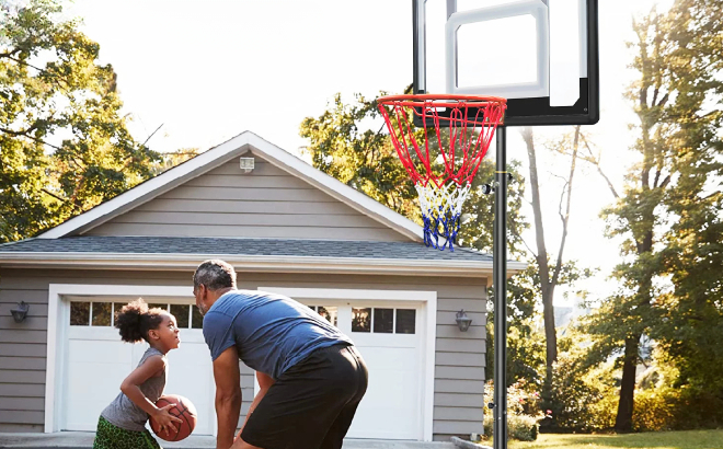 Father and Daughter Playing with Portable Basketball Hoop System Father and Daughter Playing with Portable Basketball Hoop System