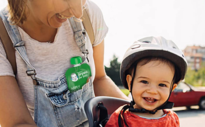 Gerber Organic Baby Food Pouch in Banana Mango Flavor in a Persons Pocket Gerber Organic Baby Food Pouch in Banana Mango Flavor in a Persons Pocket