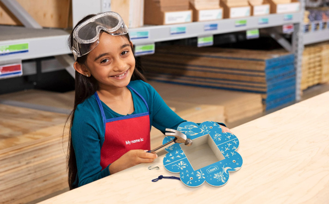 Girl making a Flower Bird Feeder at Lowes Girl making a Flower Bird Feeder at Lowes