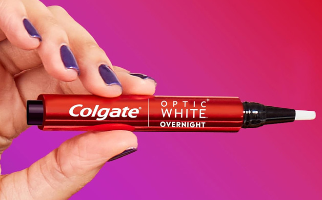 Hand Holding Colgate Optic White Overnight Teeth Whitening Pen