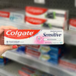 Hand Holding Colgate Sensitive Toothpaste