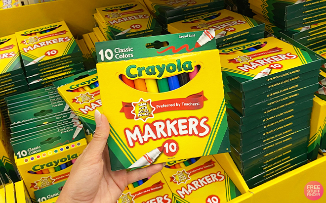 Hand Holding Crayola Broad Line Markers 10 Count at a Store