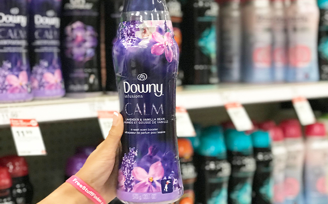 Hand Holding Downy Infusions Calm Laundry Scent Booster Beads in the Lavender Vanilla Bean Scent