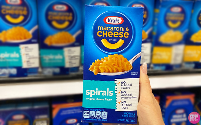 Hand Holding Kraft Spirals Macaroni and Cheese Dinner