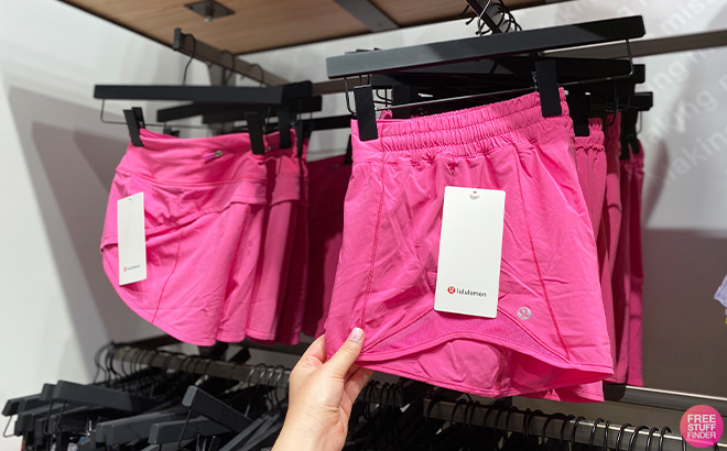 Hand Holding Lululemon Hotty Hot Low Rise Lined Shorts in Sonic Pink Color