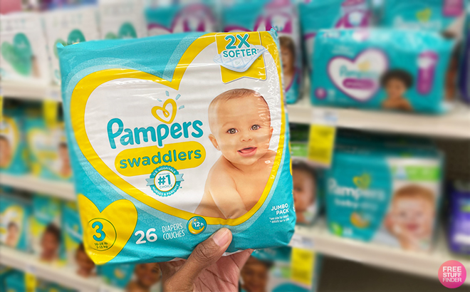 Hand Holding Pampers Swaddlers Diapers at CVS