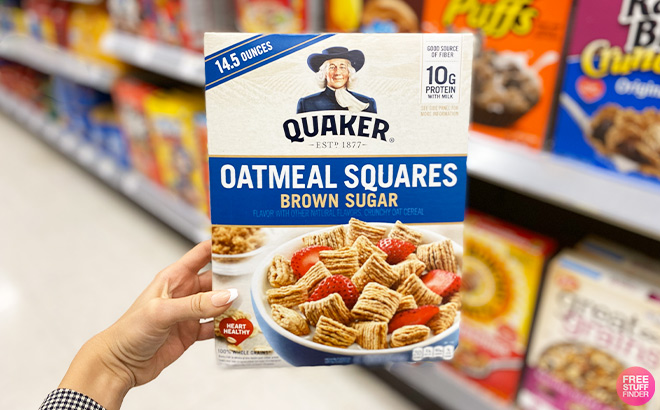 Hand Holding Quaker Oatmeal Squares Breakfast Cereal