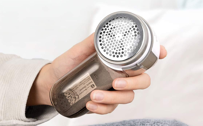Hand Holding a BEAUTURAL Fabric Shaver and Lint Remover Hand Holding a BEAUTURAL Fabric Shaver and Lint Remover