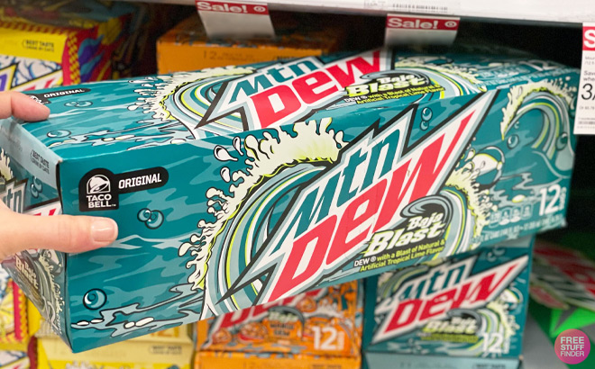 Hand Holding a Mountain Dew Baja Blast 12 Pack at Target