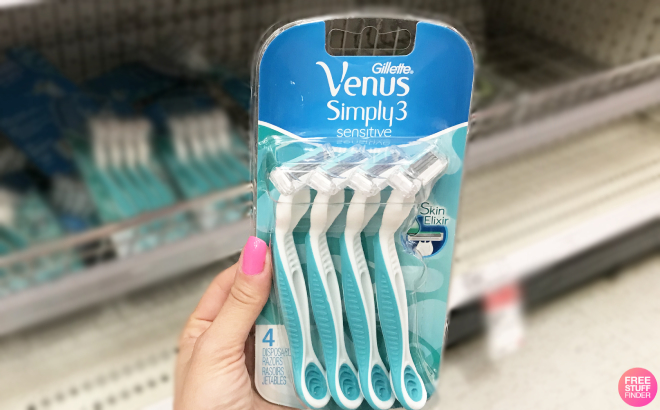 Hand Holding a Pack of Venus Simply 3 Sensitive Womens Disposable Razors