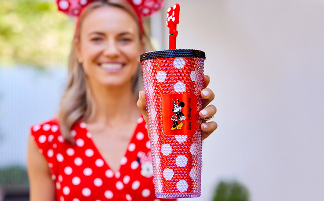 Hand holding Disney Minnie Mouse Starbucks Tumbler with Straw