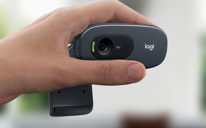 Hand holding Logitech C270 HD Webcam