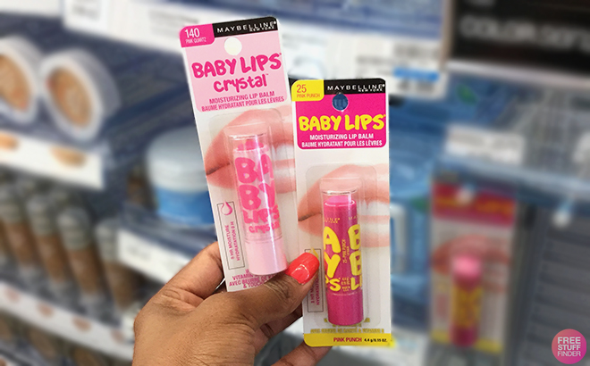 Hand holding two Maybelline Baby Lips Lip Balms