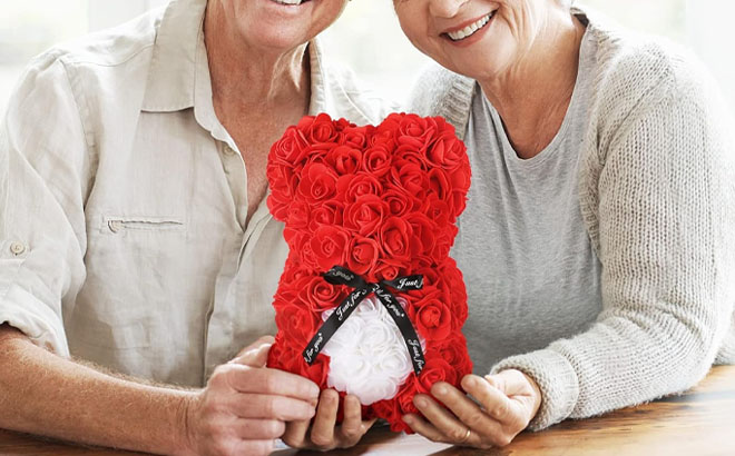 Husband and Wife Holding a Rose Bear Valentines Day Gift