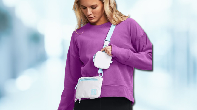 Lady using Under Armour Unisex Small Crossbody in white blizzard color