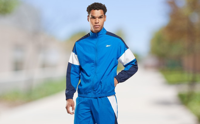 Man is Wearing Reebok Training Woven Performance Jacket in Vector Blue Color