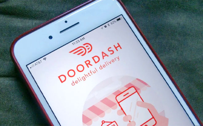 Mobile Phone on a Bed with Doordash App on the Screen