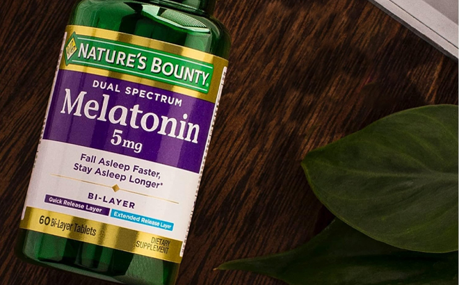 Natures Bounty Melatonin 5mg Dual Spectrum 60 Count Tablets on a Wooden Table Natures Bounty Melatonin 5mg Dual Spectrum 60 Count Tablets on a Wooden Table
