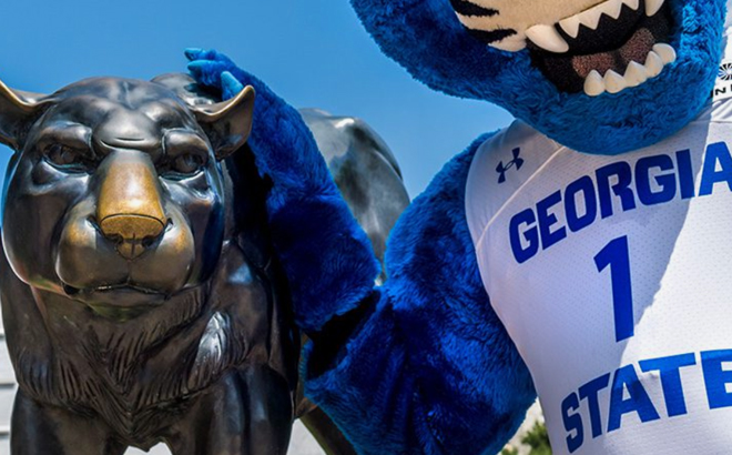 Panther Statue with boy wearing Georgia State University Costume