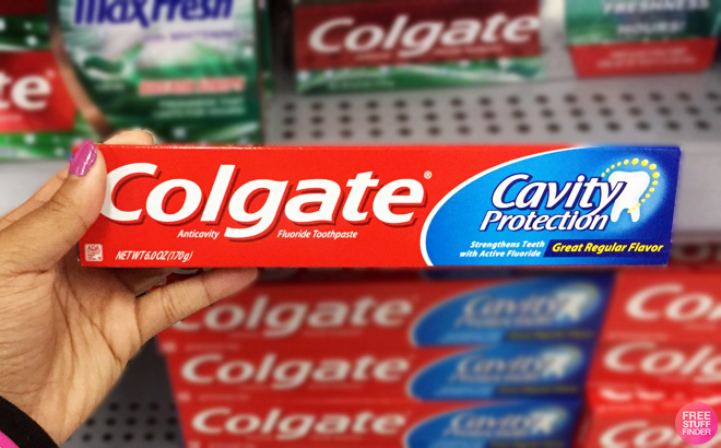 Person Holding Colgate Cavity Protection Toothpaste 6 oz