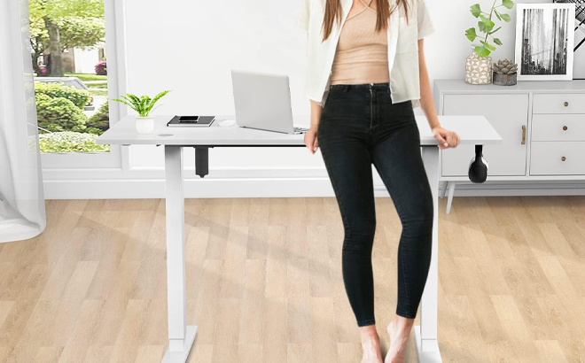 Person Leaning on Electric Height Adjustable Computer Desk
