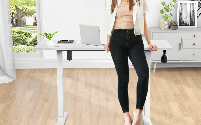 Person Leaning on Electric Height Adjustable Computer Desk Person Leaning on Electric Height Adjustable Computer Desk