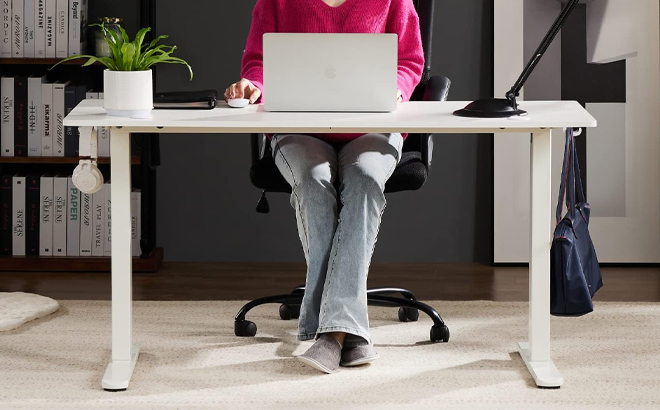 Person Sitting at a Electric Height Adjustable Computer Desk Person Sitting at a Electric Height Adjustable Computer Desk