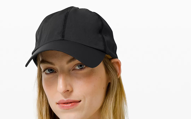 Person Wearing a Lululemon Womens Baller Hat Soft in Black