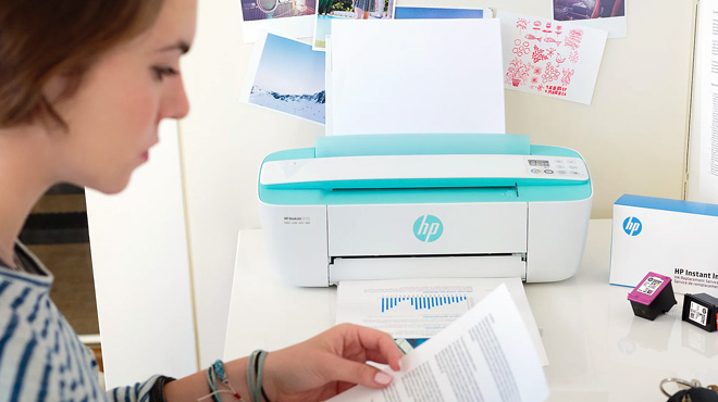 Person Working Next to HP DeskJet All in One Wireless Printer Copier Scanner