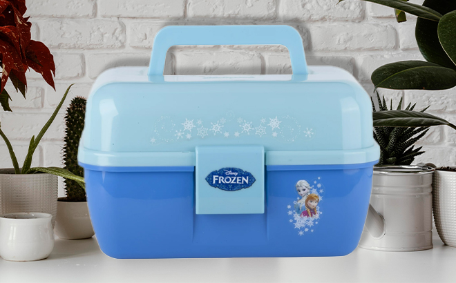 Shakespeare Disney Frozen Fishing Tackle Box on a Table with Plants