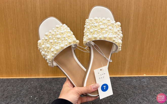 Someone holding a pair of A New Day Womens Jasmine Pearl Slide Sandals