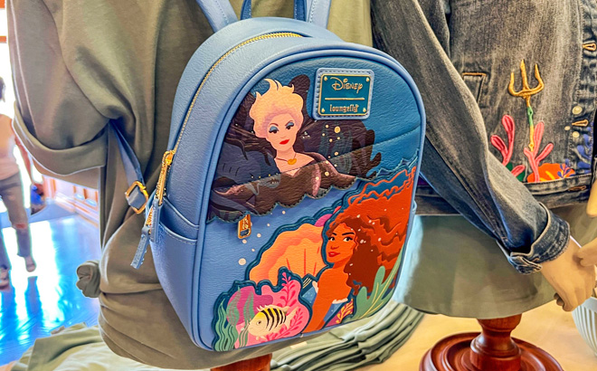 The Little Mermaid Loungefly Mini Backpack on a Display Table