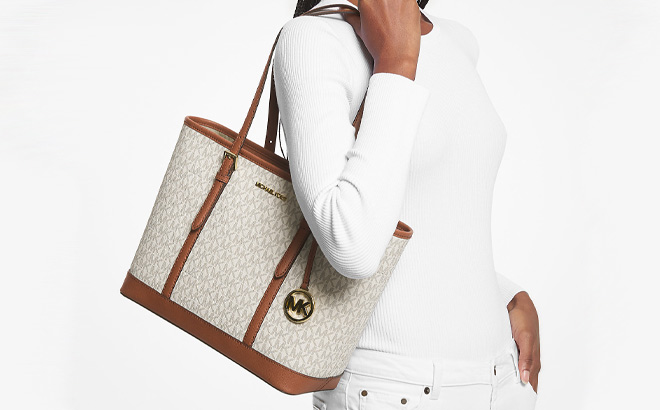 Woman is Holding Michael Kors Jet Set Travel Small Logo Top Zip Tote Bag in Vanilla Color