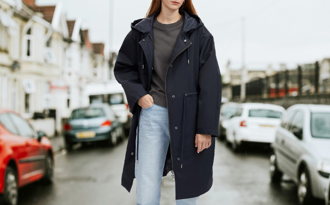 Woman is Wearing Coach Raincoat in Navy Color