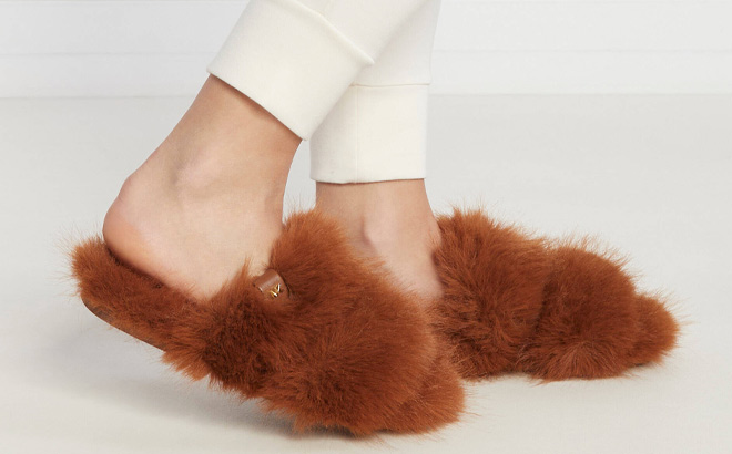 Woman is Wearing Michael Kors Tula Faux Fur Slides in Luggage Color