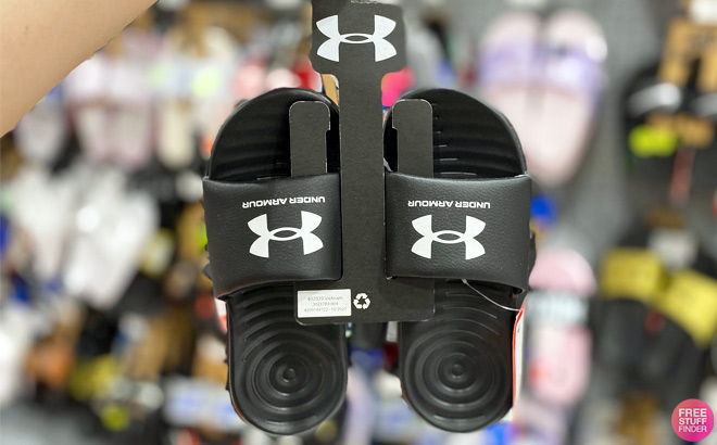 Women Holding Under Armour Ansa Fixed Slides in Black Color